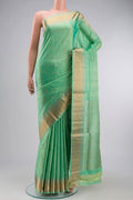 Green Soft Silk Saree with Zari Butta on the body and Zari Border displayed on a mannequin