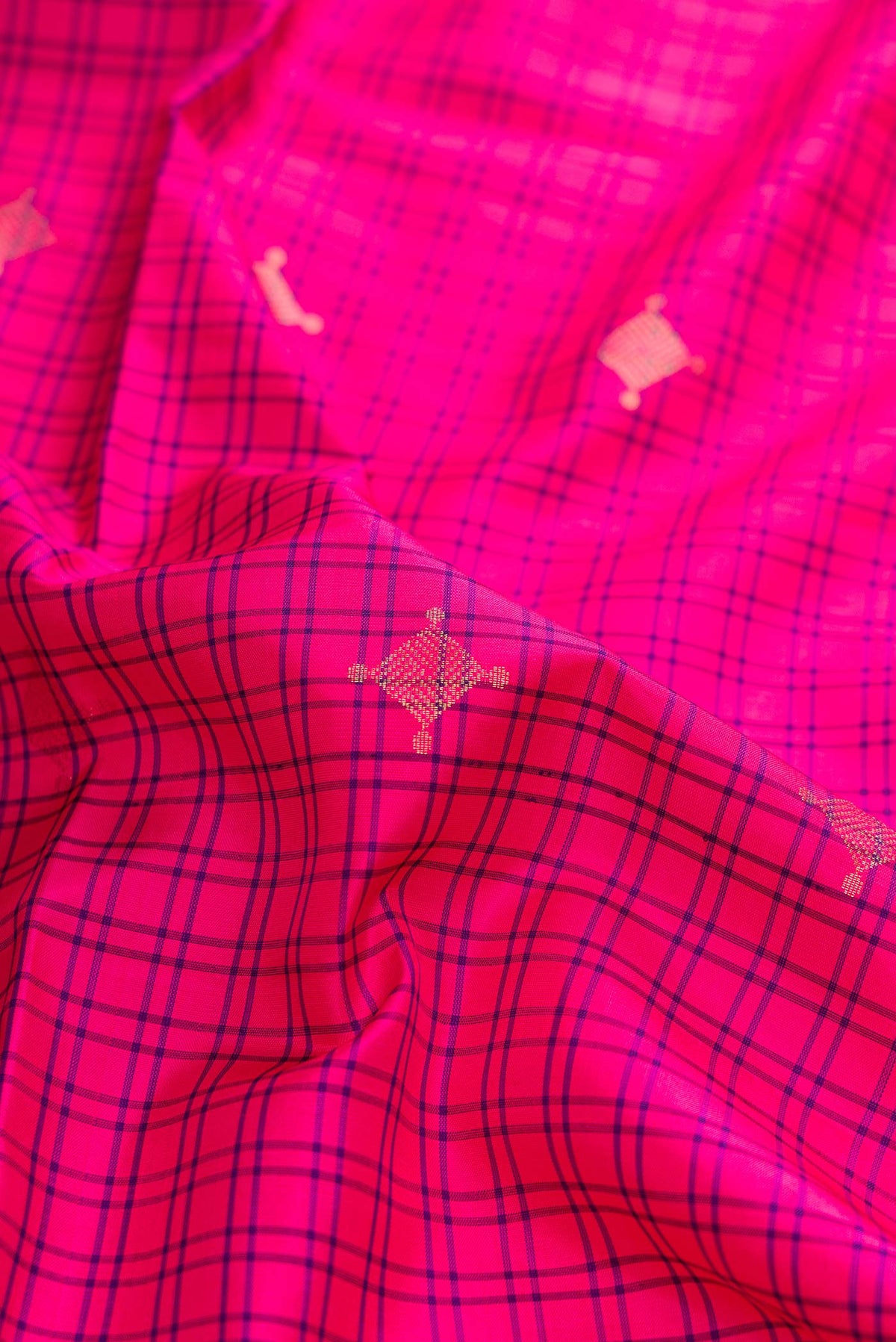 Close up of Pink Dual Tone Soft Silk Saree with Checked design on the body and Zari Border displaying folds