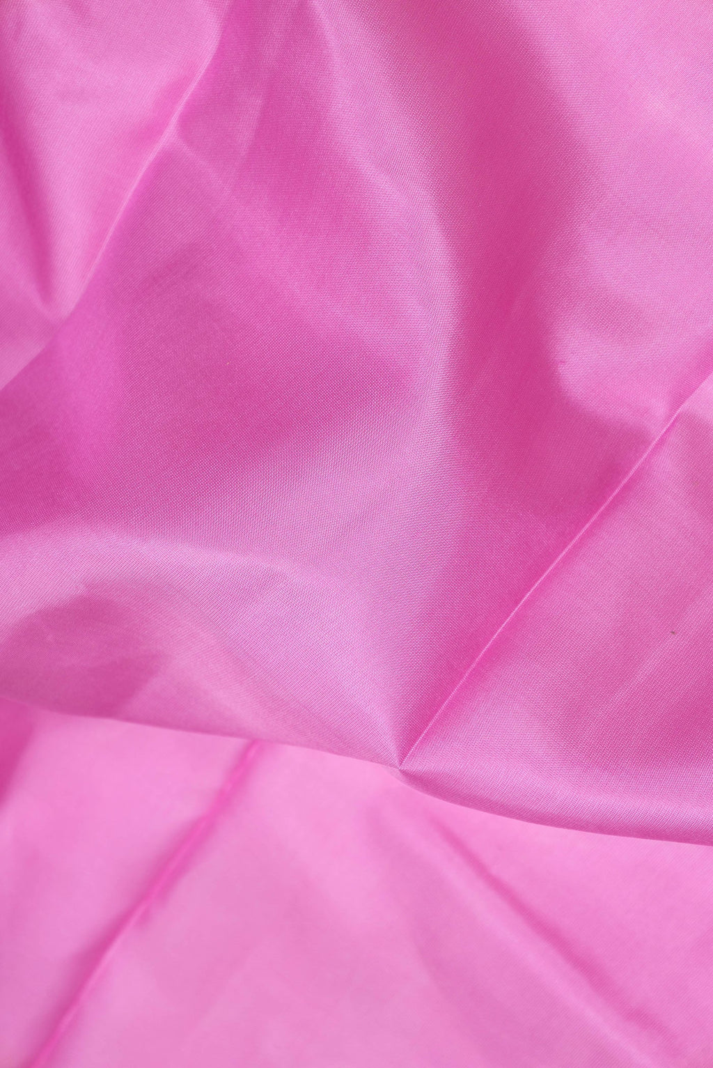 Close up of Pink Dual Tone Kanchipuram Silk Saree with Zari Butta on the body and Zari Border.  displaying folds
