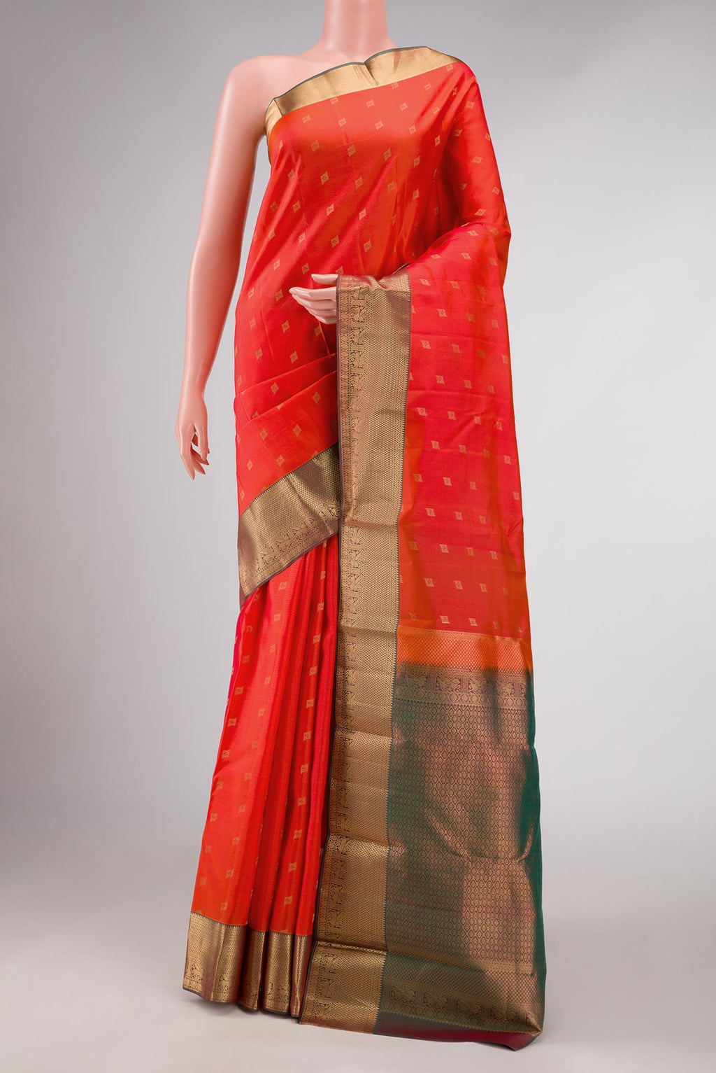 Orange Dual Tone Kanchipuram Silk Saree with Zari Butta on the body and Zari Border displayed on a mannequin