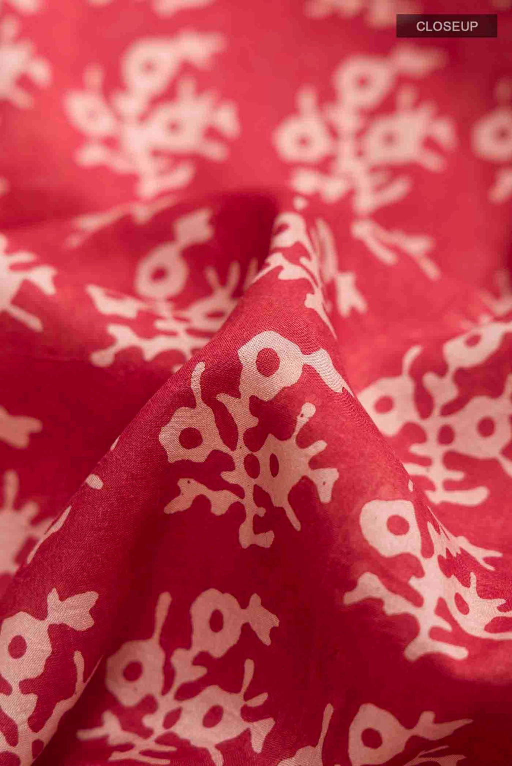 Close up of Rust Printed Silk Saree with Printed design on the body and Printed Border displaying folds