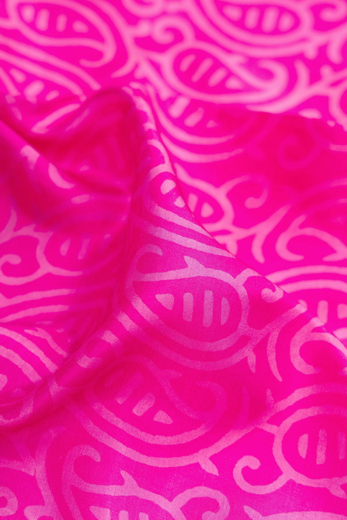 Close up of Pink Printed Silk Saree with Printed design on the body and Printed Border.  displaying folds