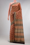 Rust Printed Silk Saree with Printed design on the body and Printed Border.  displayed on a mannequin