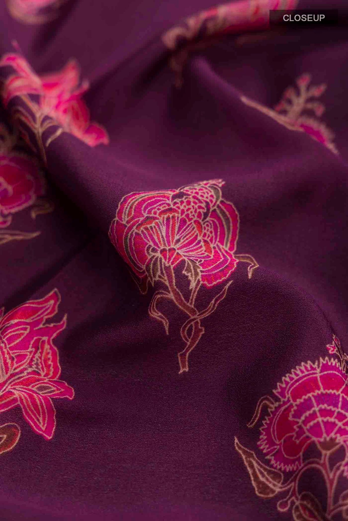 Close up of Purple Mysore Crepe Saree with Printed design on the body and Zari Border displaying folds