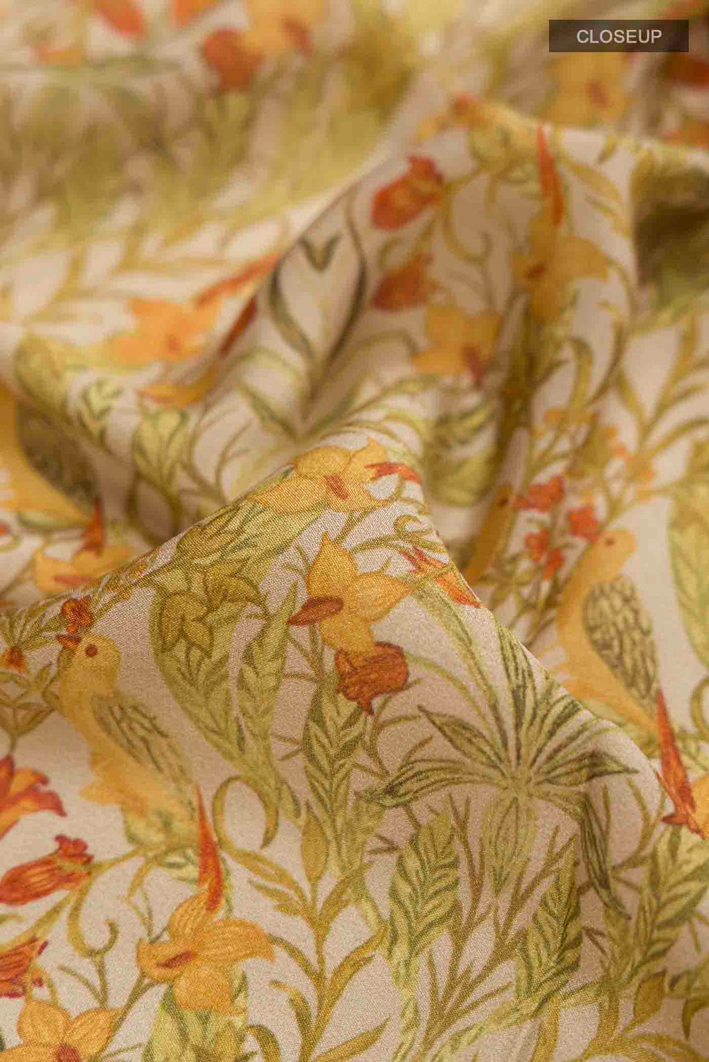 Close up of Green Mysore Crepe Saree with Printed design on the body and Zari Border displaying folds