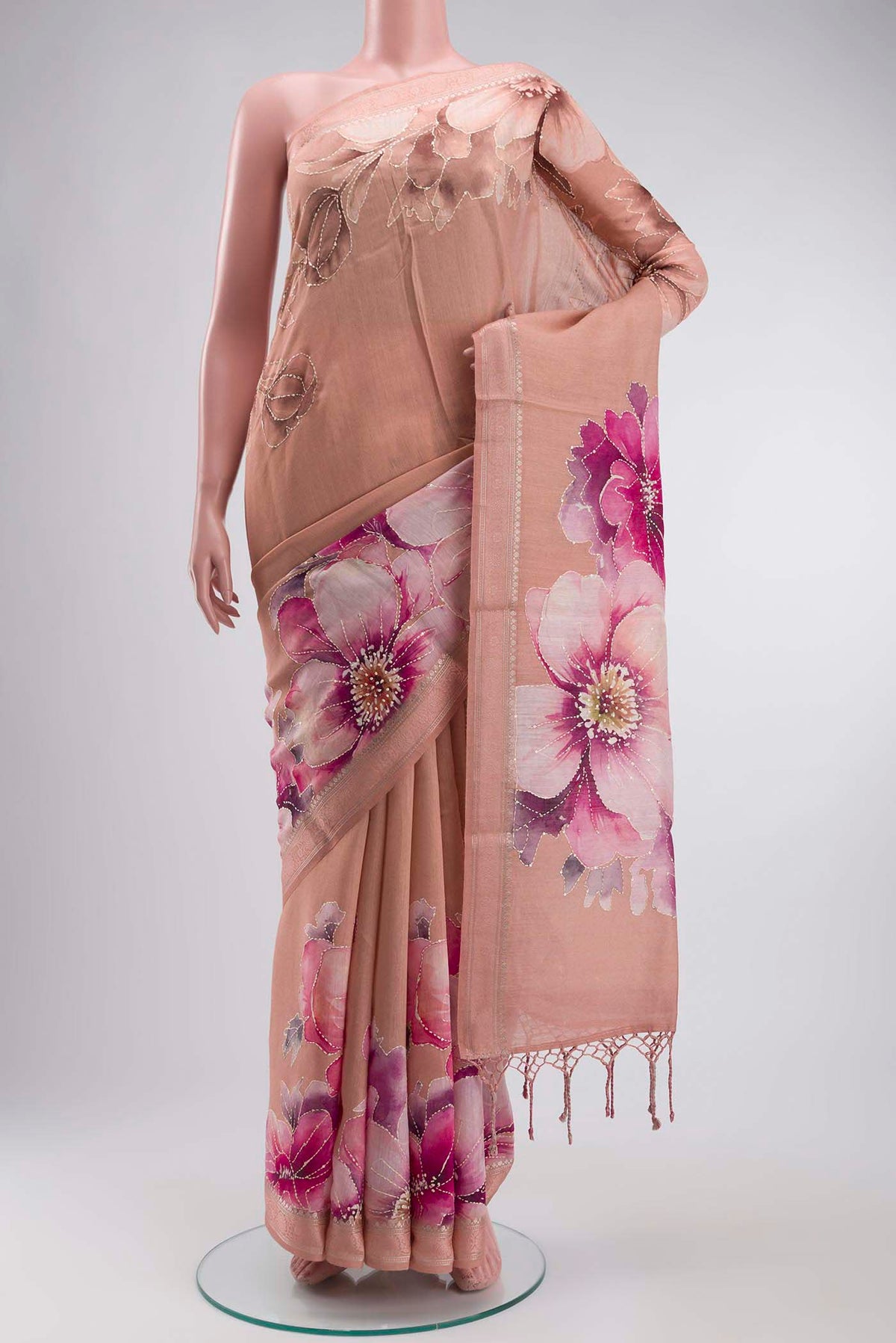 Peach Tussar Silk Saree with Embroidery on the body and Zari And Thread Border displayed on a mannequin