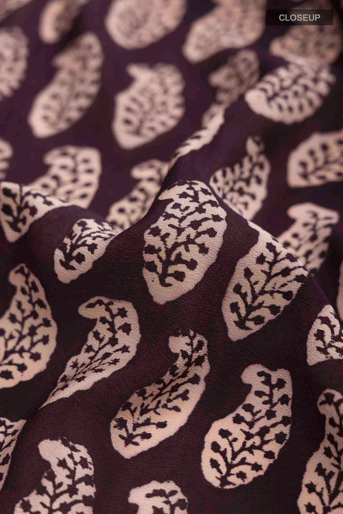 Close up of Black Mysore Crepe Saree with Printed design on the body and Printed Border displaying folds