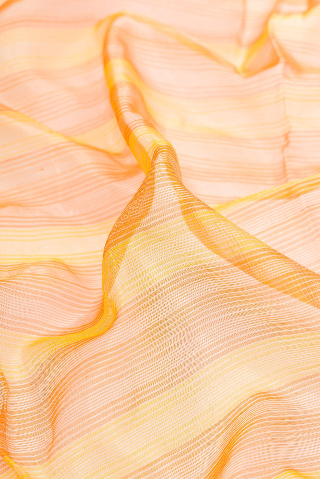 Close up of Orange and Yellow Color Maheshwari Silk Saree with Stripes on the body and Zari Border.  displaying folds