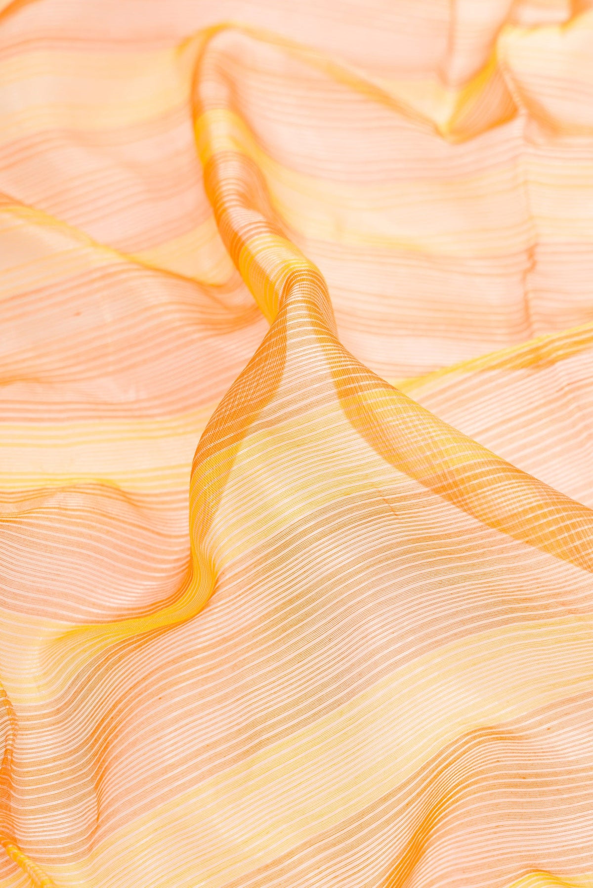 Close up of Orange and Yellow Color Maheshwari Silk Saree with Stripes on the body and Zari Border.  displaying folds