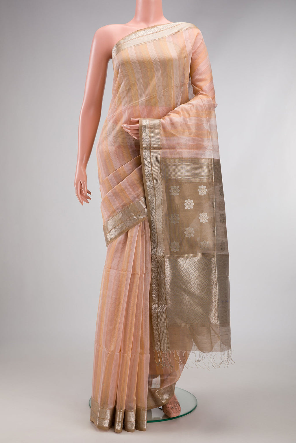 Rose Gold Maheshwari Silk Cotton Saree with Stripes on the body and Zari Border.  displayed on a mannequin