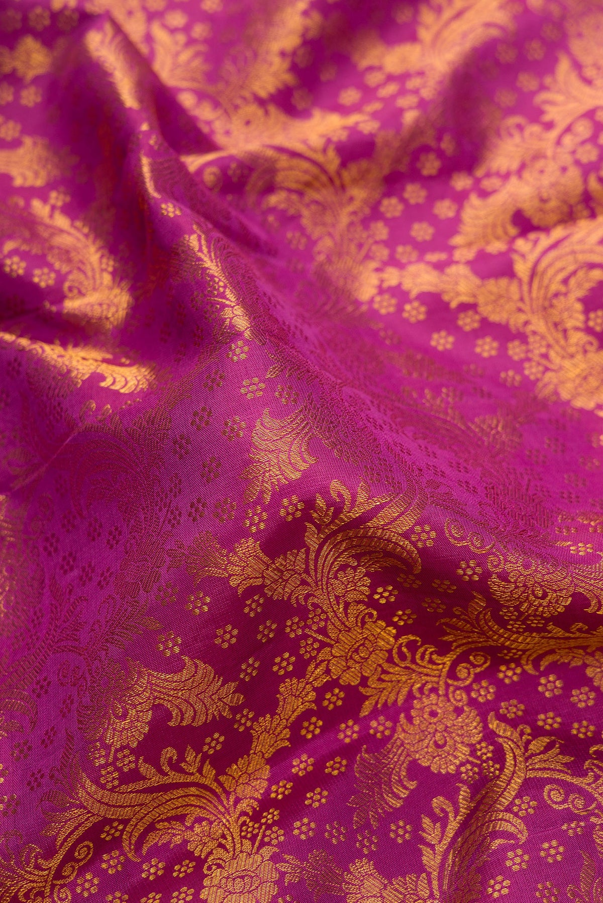 Close up of Purple Dual Tone Kanchipuram Silk Saree with Zari Brocade on the body and Zari Border.  displaying folds