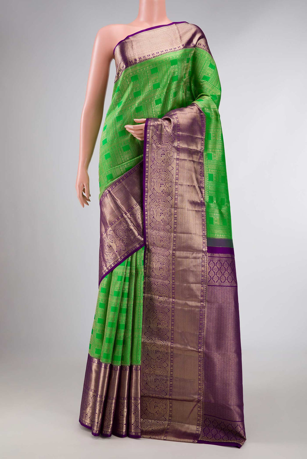 Green Dual Tone Kanchipuram Silk Saree with Zari Brocade on the body and Zari Border displayed on a mannequin