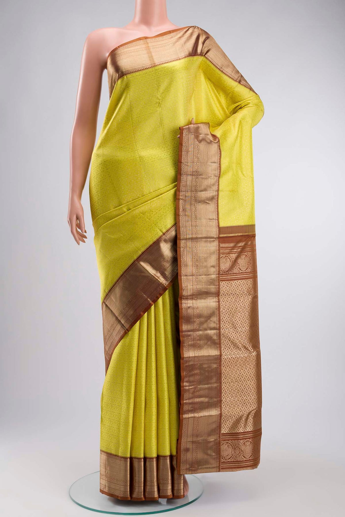 Yellow Kanchipuram Silk Saree with Zari Brocade on the body and Zari Border displayed on a mannequin