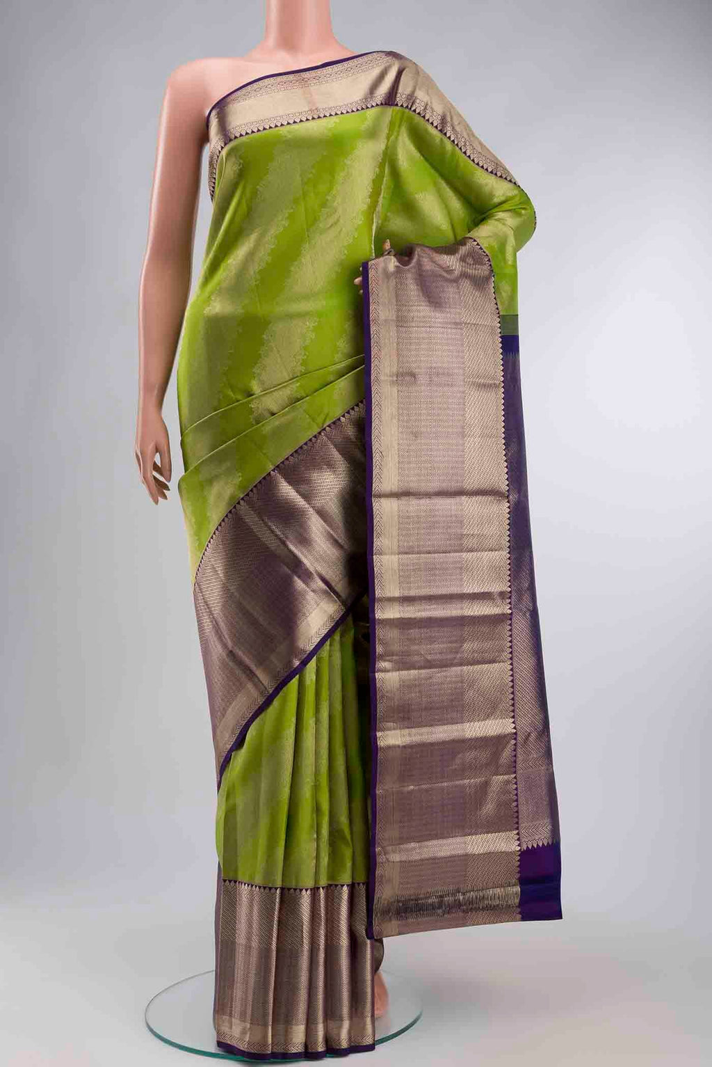 Green Kanchipuram Silk Saree with Zari Butta on the body and Zari Border displayed on a mannequin