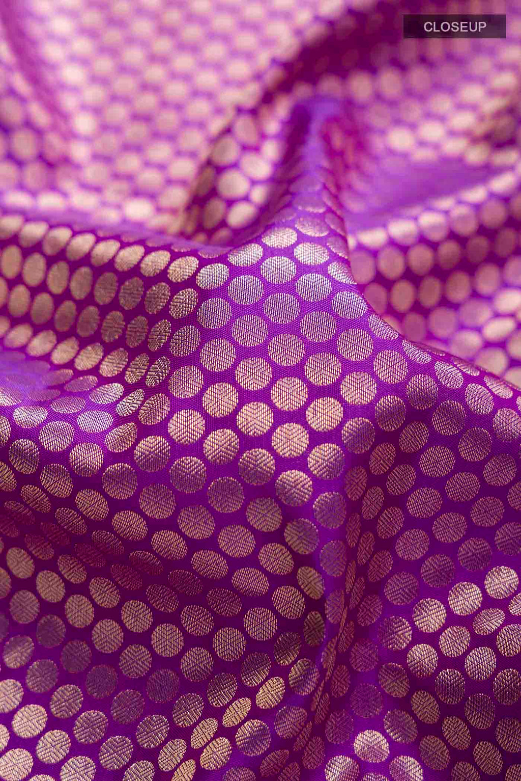 Close up of Violet Kanchipuram Silk Saree with Zari Brocade on the body and Zari Border displaying folds