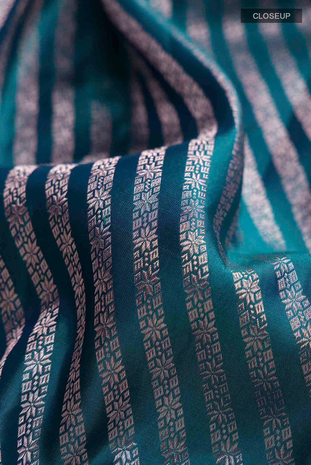 Close up of Blue Kanchipuram Silk Saree with Zari Brocade on the body and Zari Border displaying folds