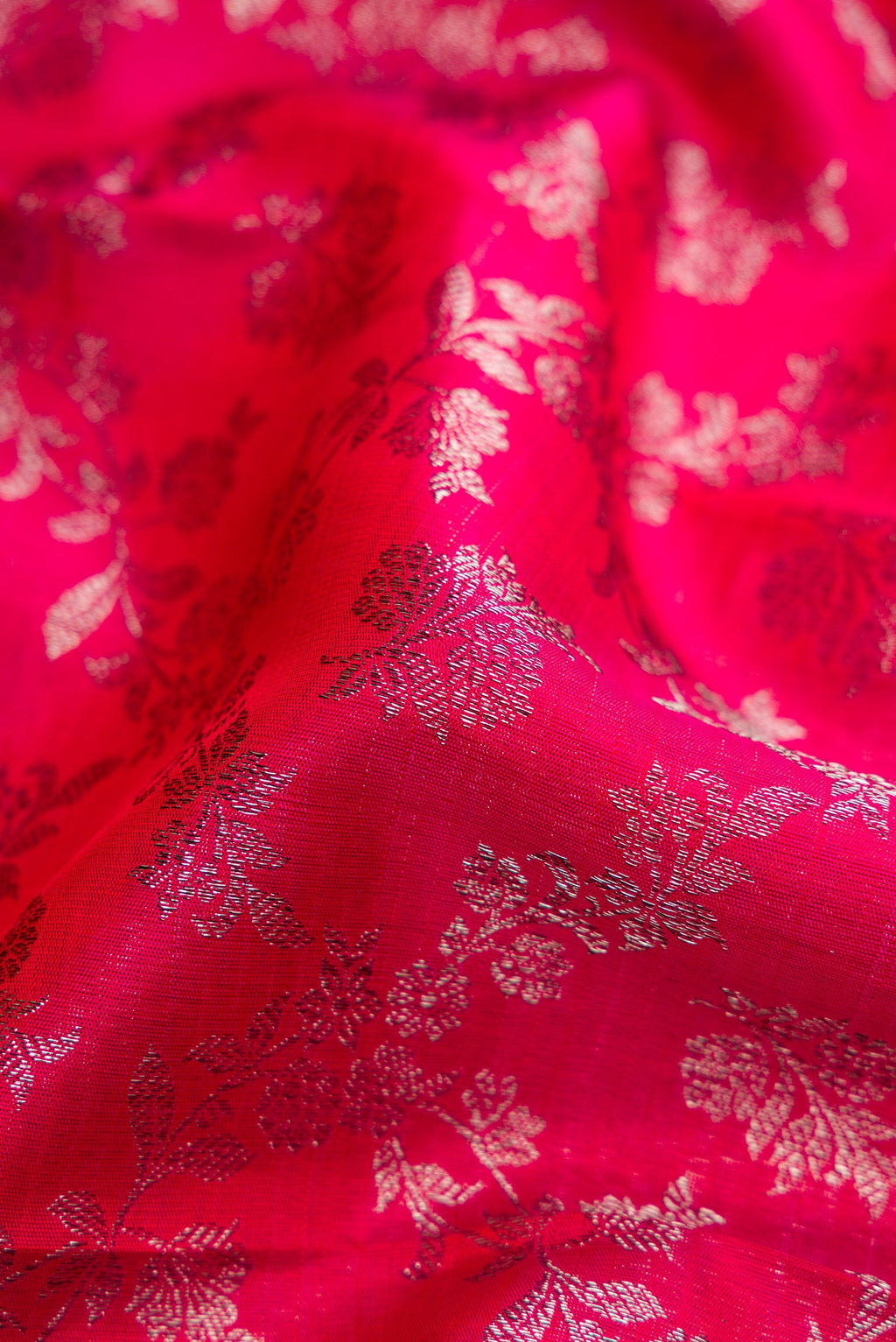 Close up of Dark Pink Dual Tone Kanchipuram Silk Saree with Zari Brocade on the body and Zari Border.  displaying folds