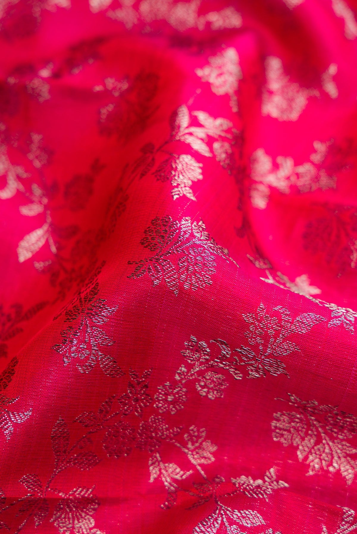 Close up of Dark Pink Dual Tone Kanchipuram Silk Saree with Zari Brocade on the body and Zari Border.  displaying folds