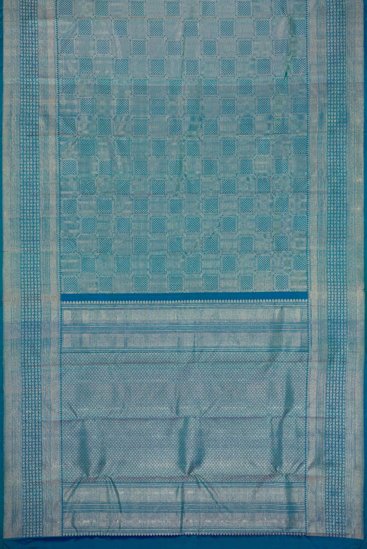 Flat view of Peacock Blue Dual Tone Kanchipuram Silk Saree with Zari Brocade on the body and Zari Border. 