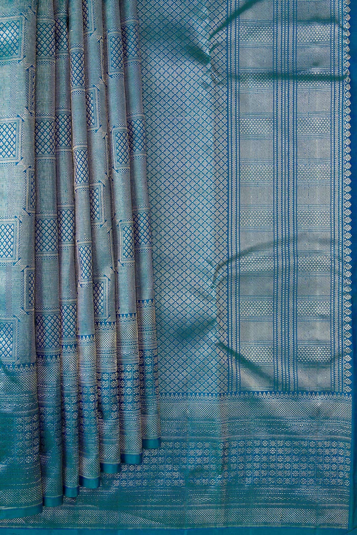 Pleats and pallu of Peacock Blue Dual Tone Kanchipuram Silk Saree with Zari Brocade on the body and Zari Border. 