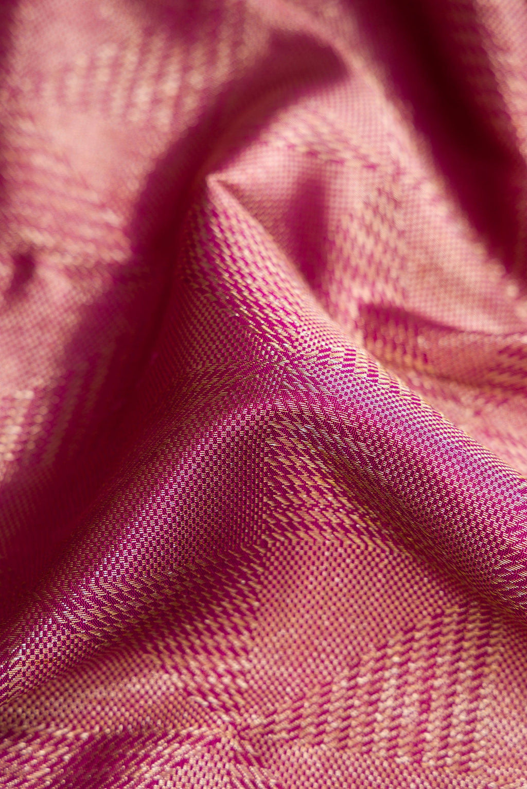 Close up of Magenta Dual Tone Kanchipuram Silk Saree with Zari Brocade on the body and Zari Border.  displaying folds