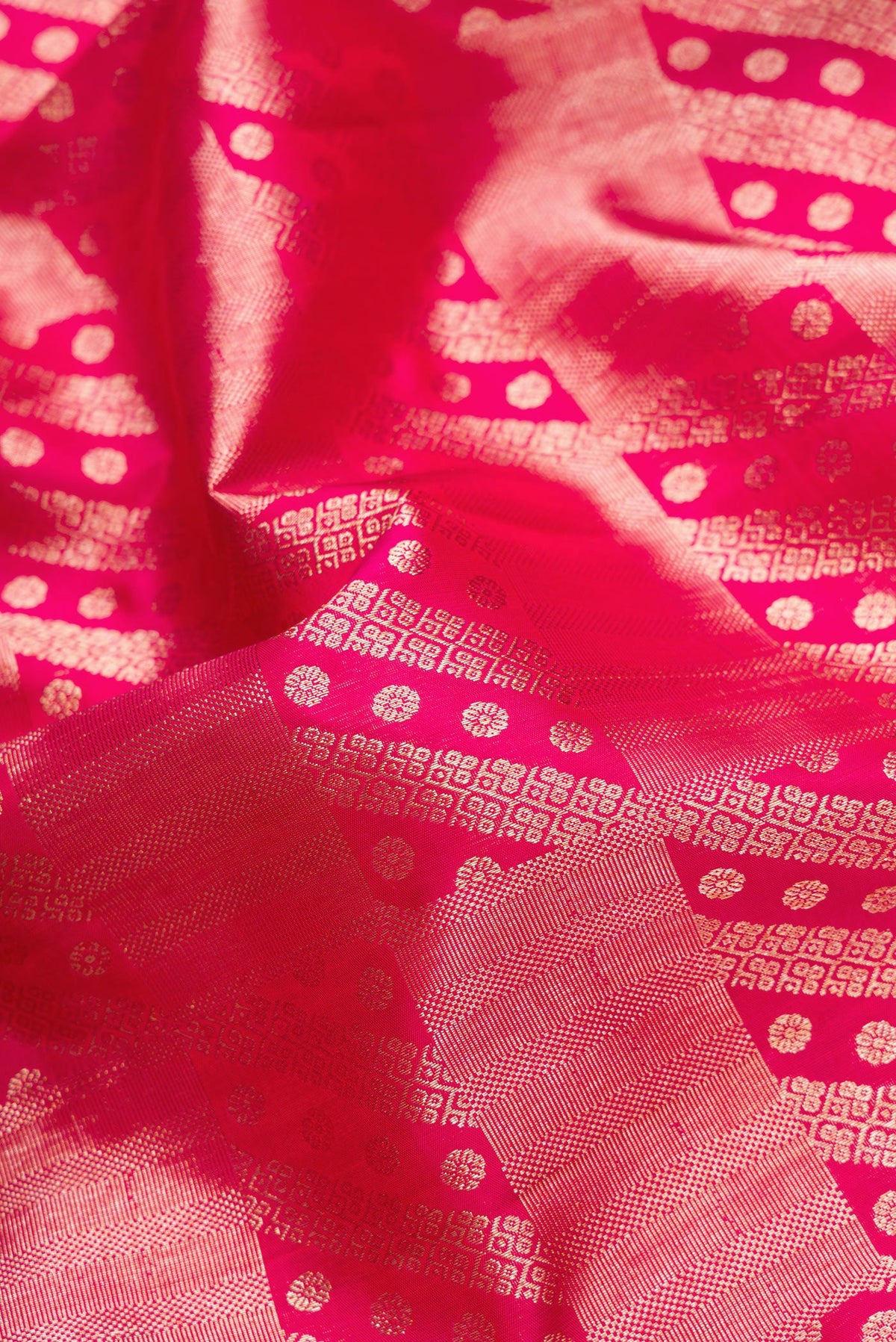 Close up of Pink Dual Tone Kanchipuram Silk Saree with Zari Brocade on the body and Zari Border.  displaying folds