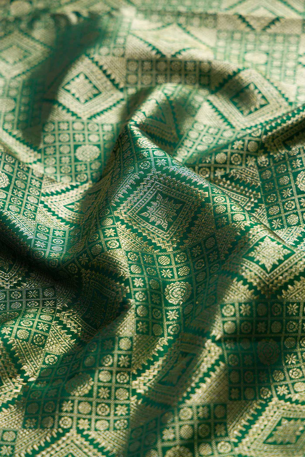 Close up of Bottle Green Dual Tone Kanchipuram Saree with Zari Brocade on the body and Zari Border displaying folds