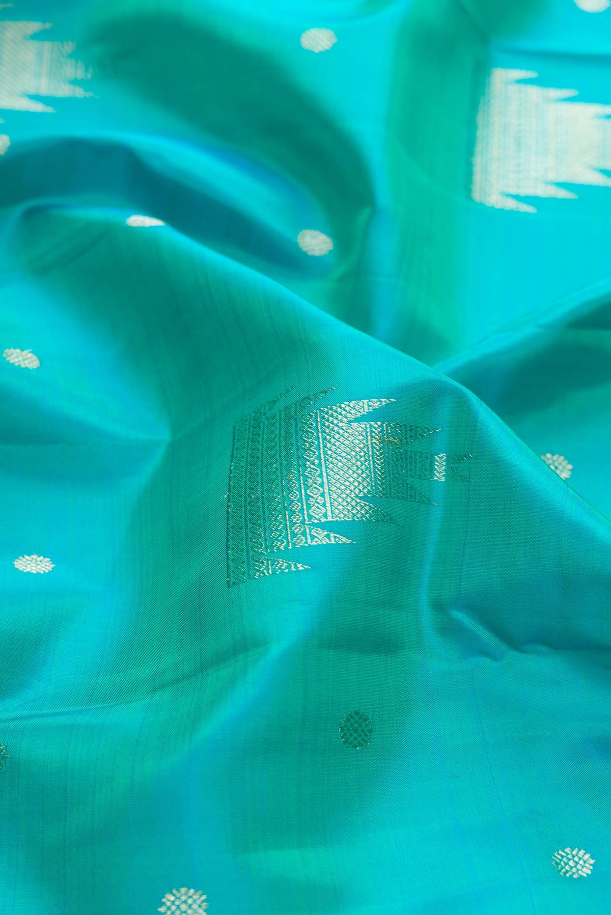 Close up of Blue Kanchipuram Silk Saree with Zari Butta on the body and Zari Border displaying folds