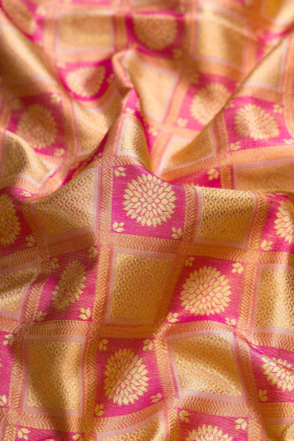 Close up of Pink Dual Tone Kanchipuram Tissue Silk Saree with Zari Brocade on the body and Zari Border displaying folds