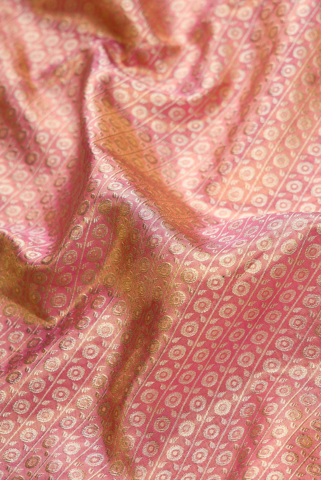 Close up of Pink Dual Tone Kanchipuram Tissue Silk Saree with Zari Brocade on the body and Zari Border.  displaying folds