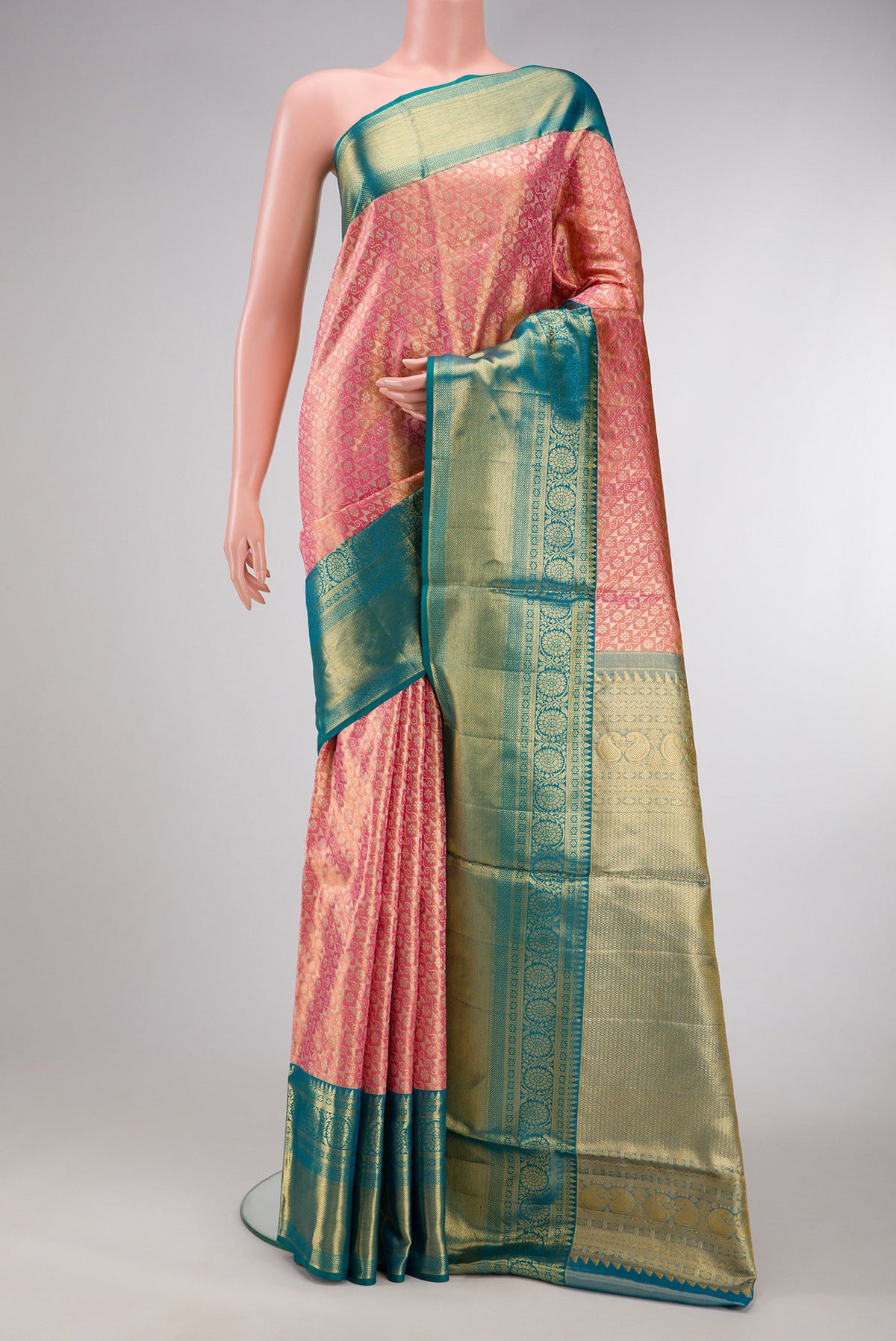 Golden Peach Dual Tone Kanchipuram Tissue Silk Saree with Zari Brocade on the body and Zari Border.  displayed on a mannequin