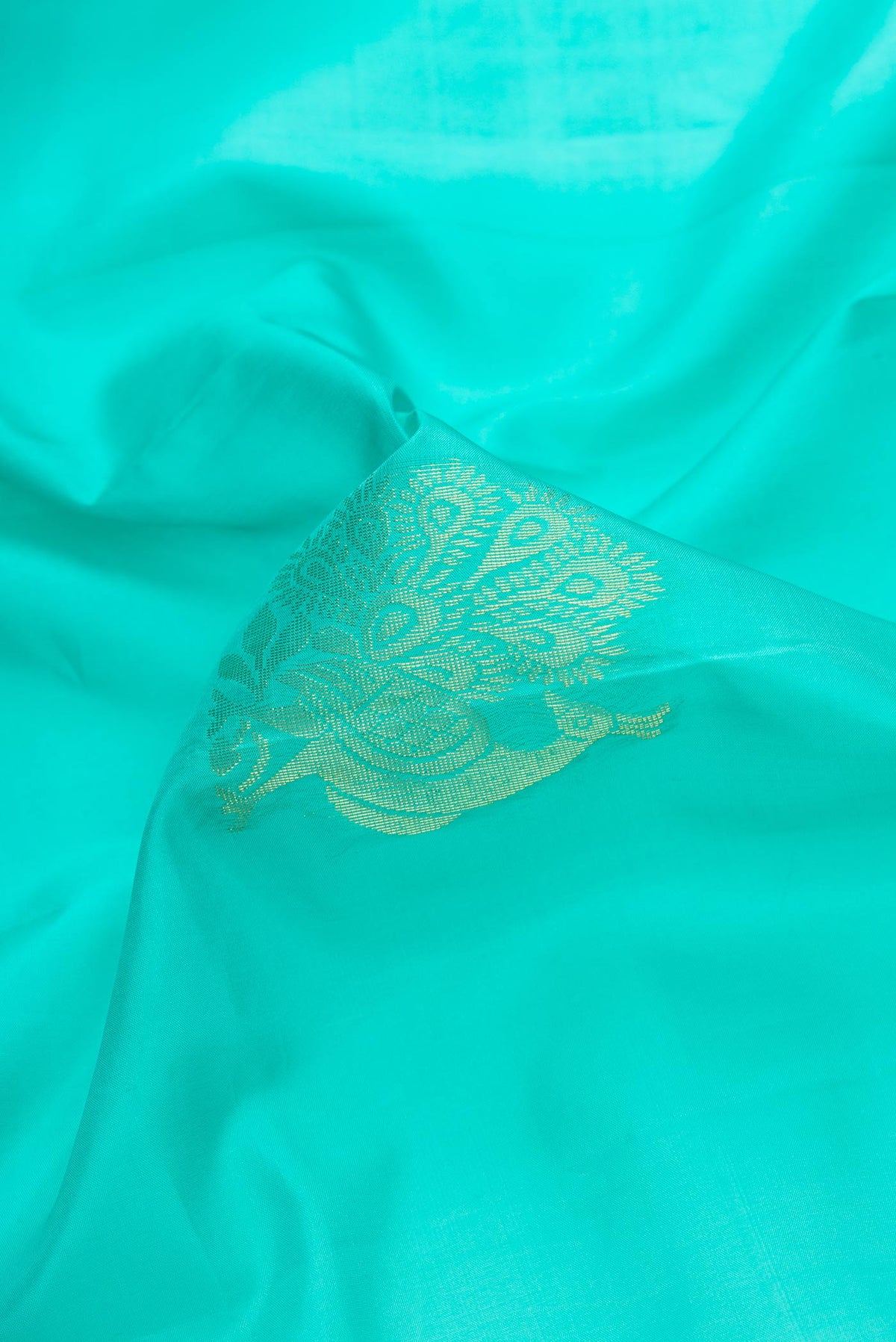 Close up of Sky Blue Dual Tone Soft Silk Saree with Zari Butta on the body and Zari Border.  displaying folds