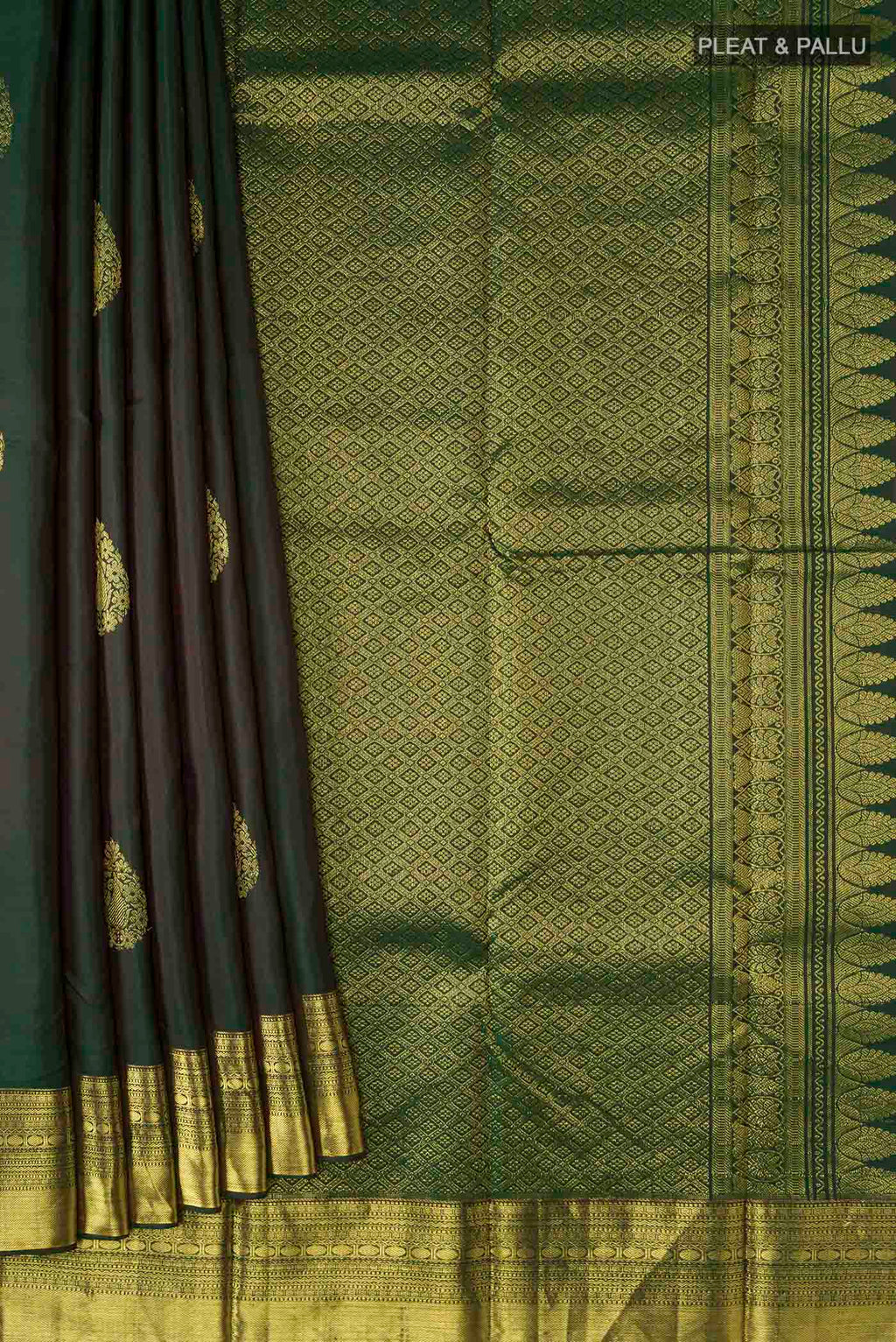 Pleats and pallu of Green Kanchipuram Silk Saree with Zari Butta on the body and Zari Border