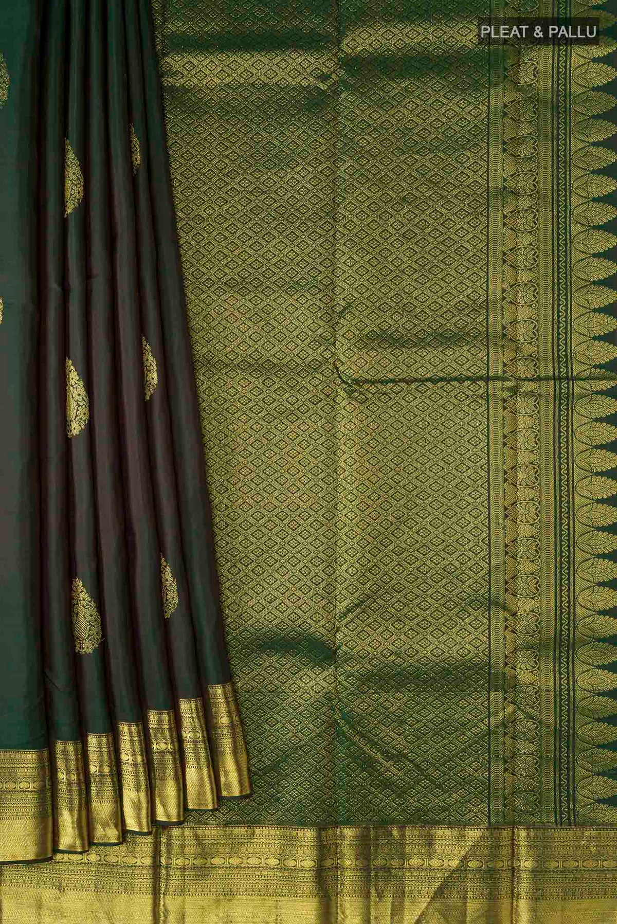 Pleats and pallu of Green Kanchipuram Silk Saree with Zari Butta on the body and Zari Border
