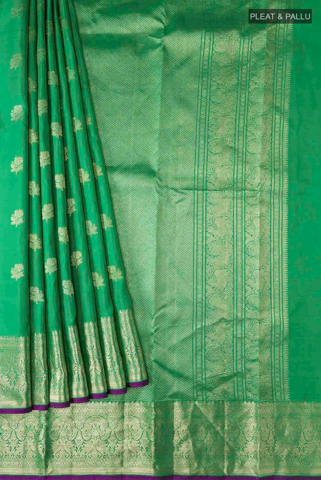 Pleats and pallu of Green Kanchipuram Silk Saree with Zari Butta on the body and Zari Border