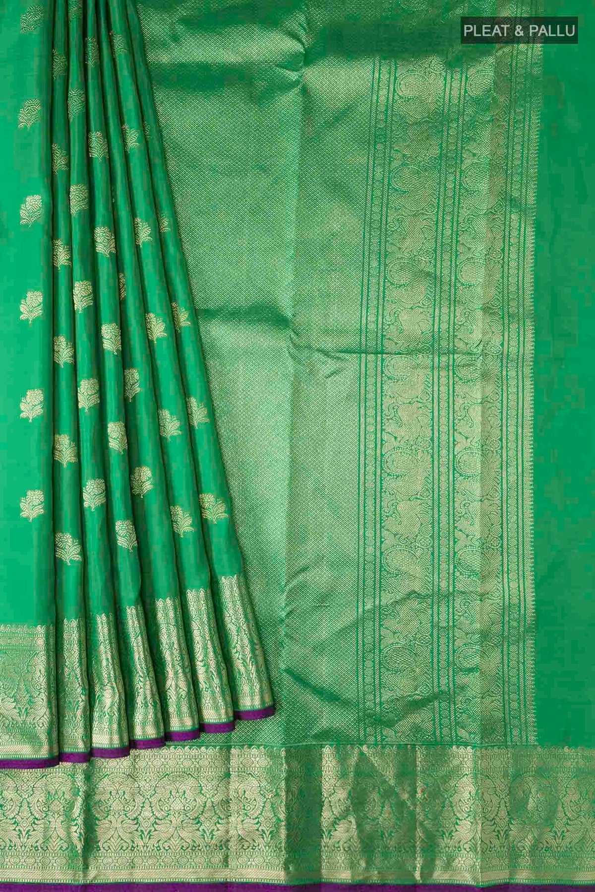 Pleats and pallu of Green Kanchipuram Silk Saree with Zari Butta on the body and Zari Border