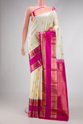 Off White Dual Tone Kanchipuram Silk Saree with Zari Butta on the body and Zari Border.  displayed on a mannequin