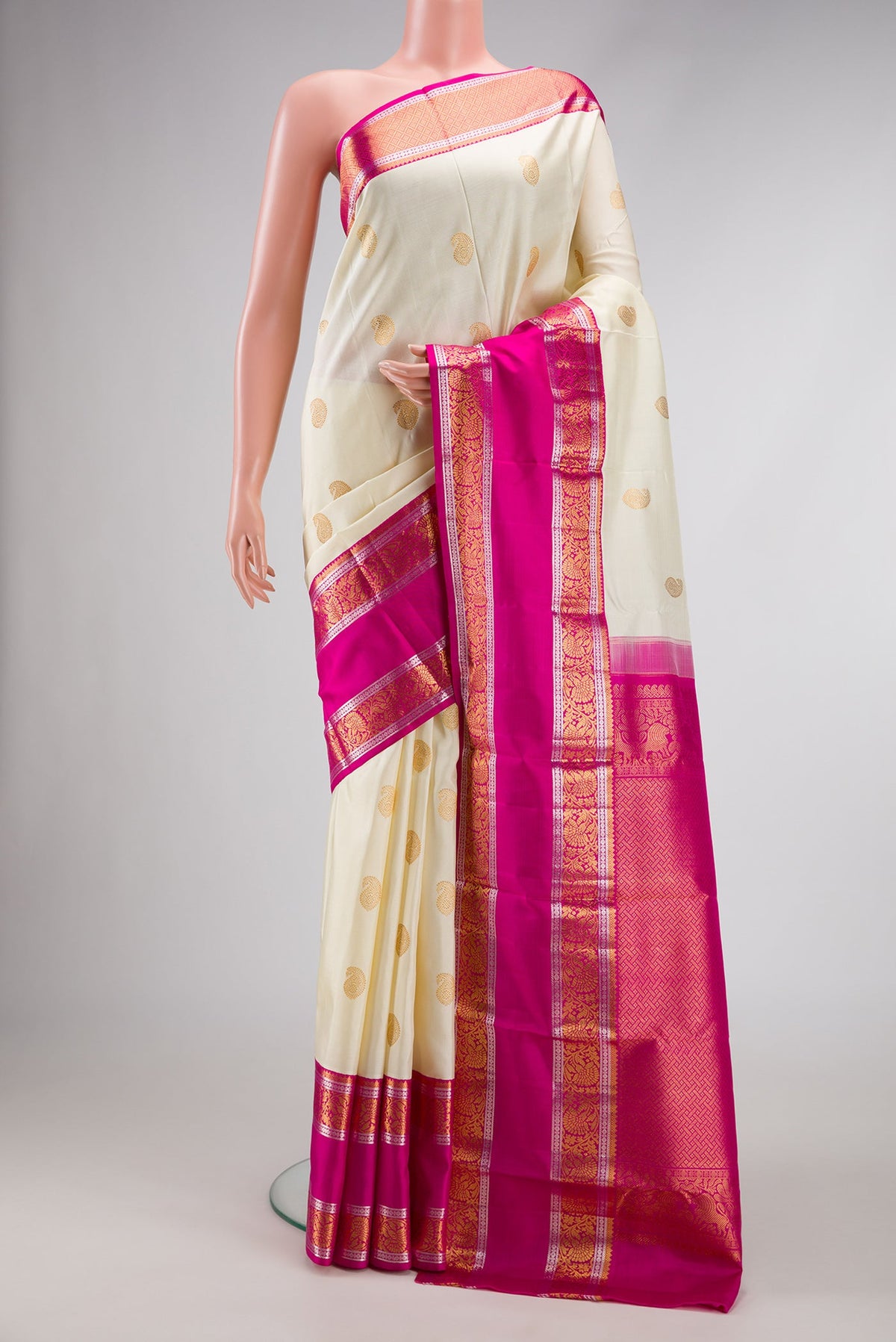Off White Dual Tone Kanchipuram Silk Saree with Zari Butta on the body and Zari Border.  displayed on a mannequin