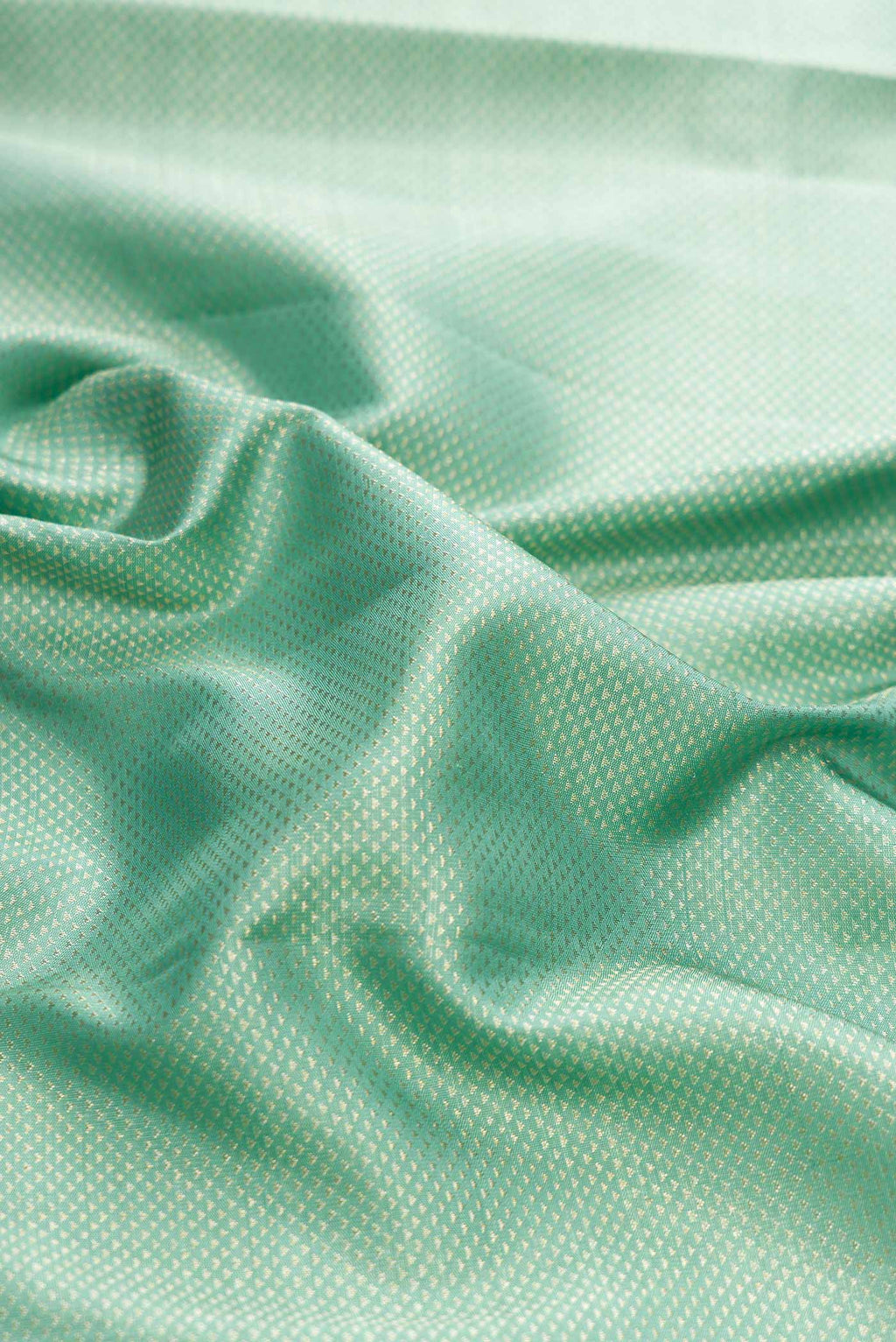Close up of Light Blue Kanchipuram Silk Saree with Zari Brocade on the body and Zari Border displaying folds