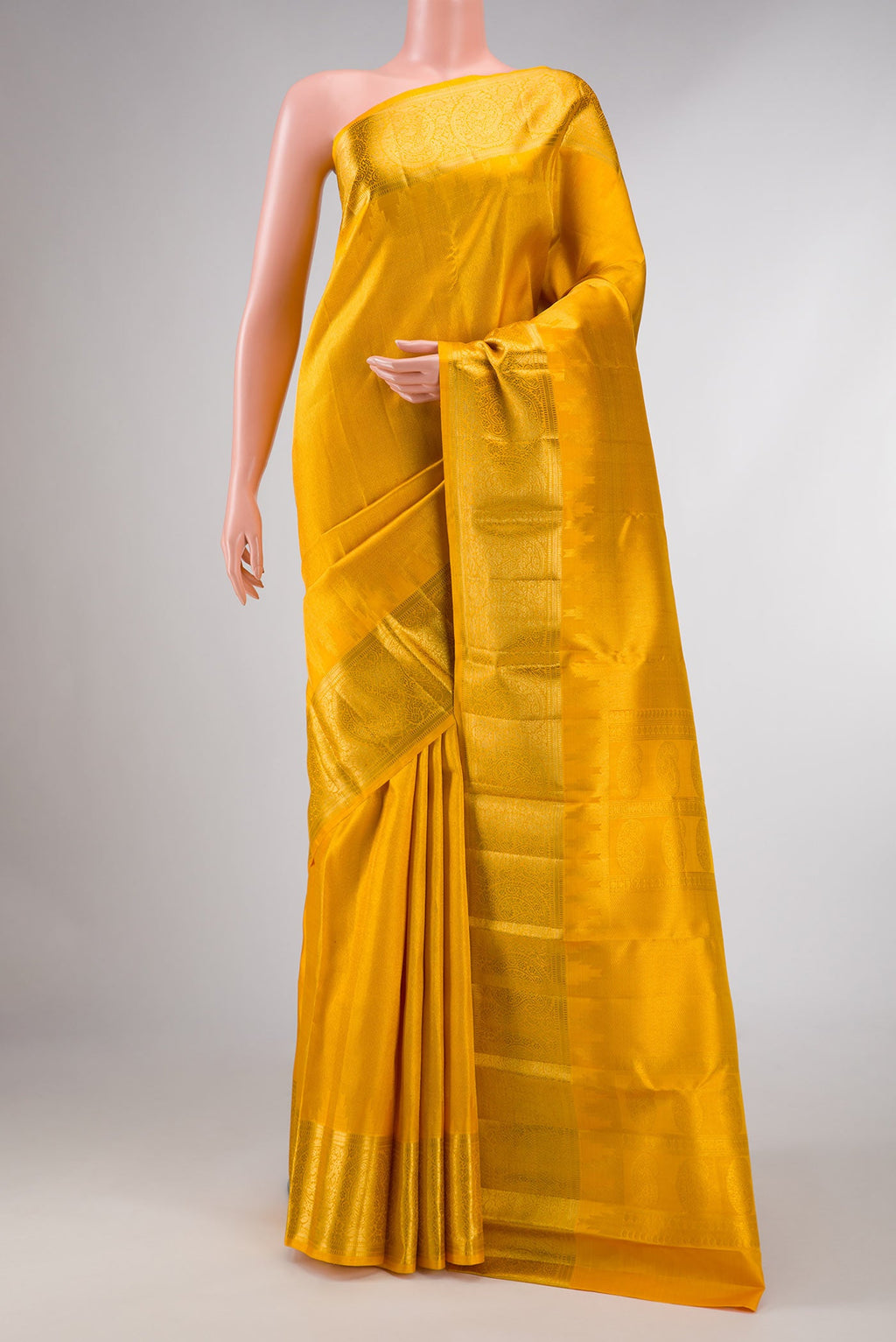 Mustard Dual Tone Kanchipuram Silk Saree with Zari Brocade on the body and Zari Border displayed on a mannequin