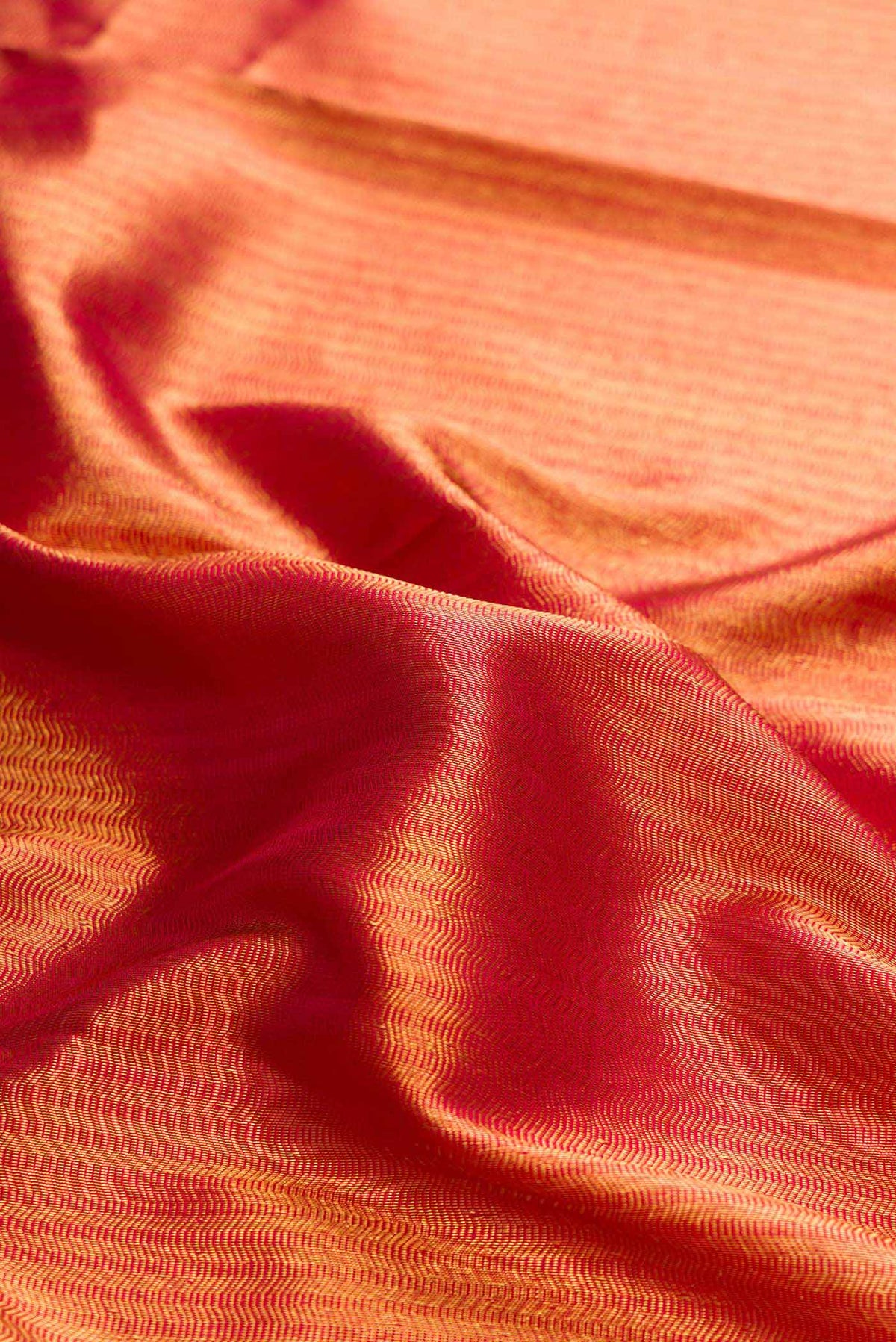 Close up of Maroon Dual Tone Kanchipuram Silk Saree with Zari Brocade on the body and Zari Border displaying folds