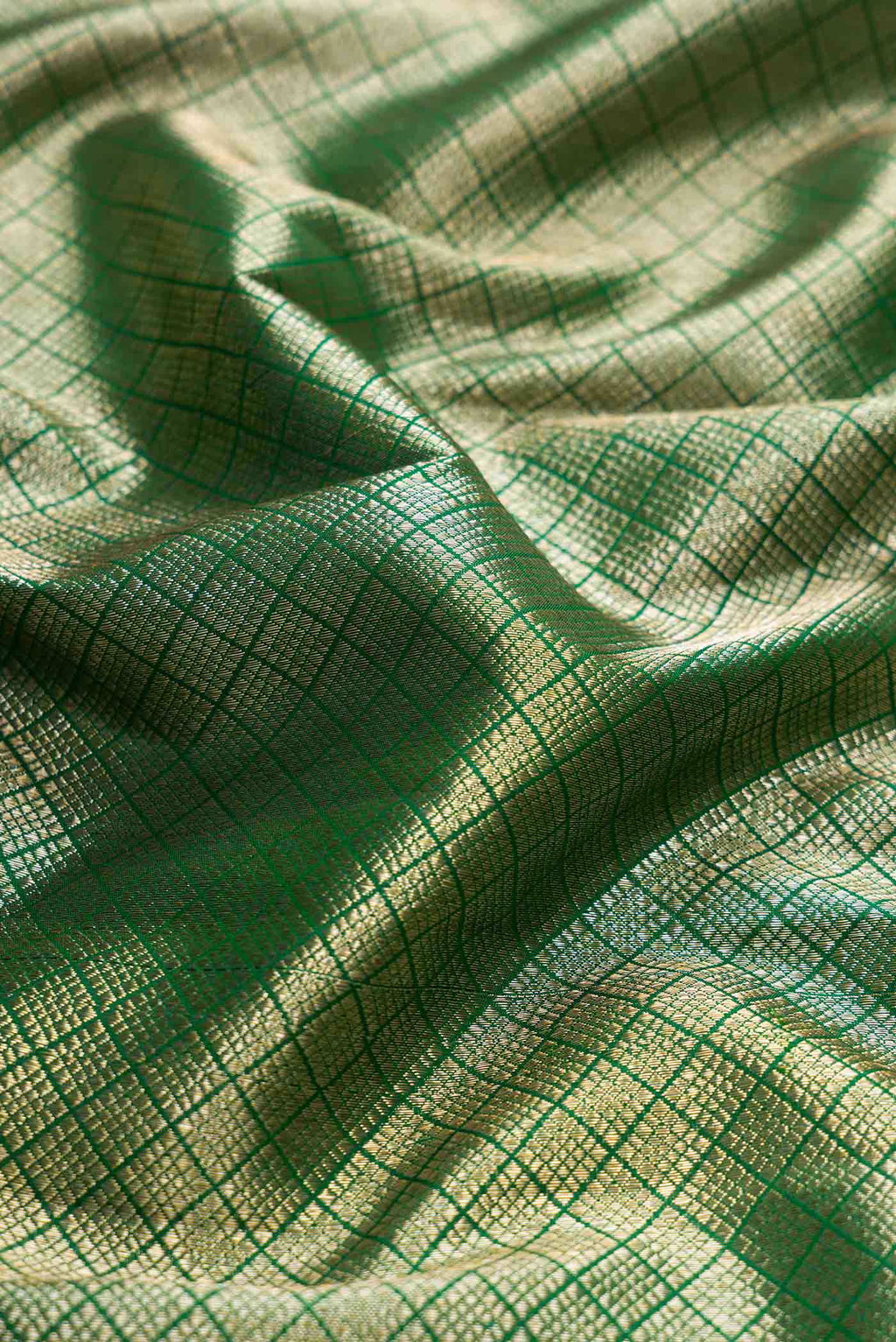 Close up of Green Dual Tone Kanchipuram Silk Saree with Zari Brocade on the body and Zari Border displaying folds