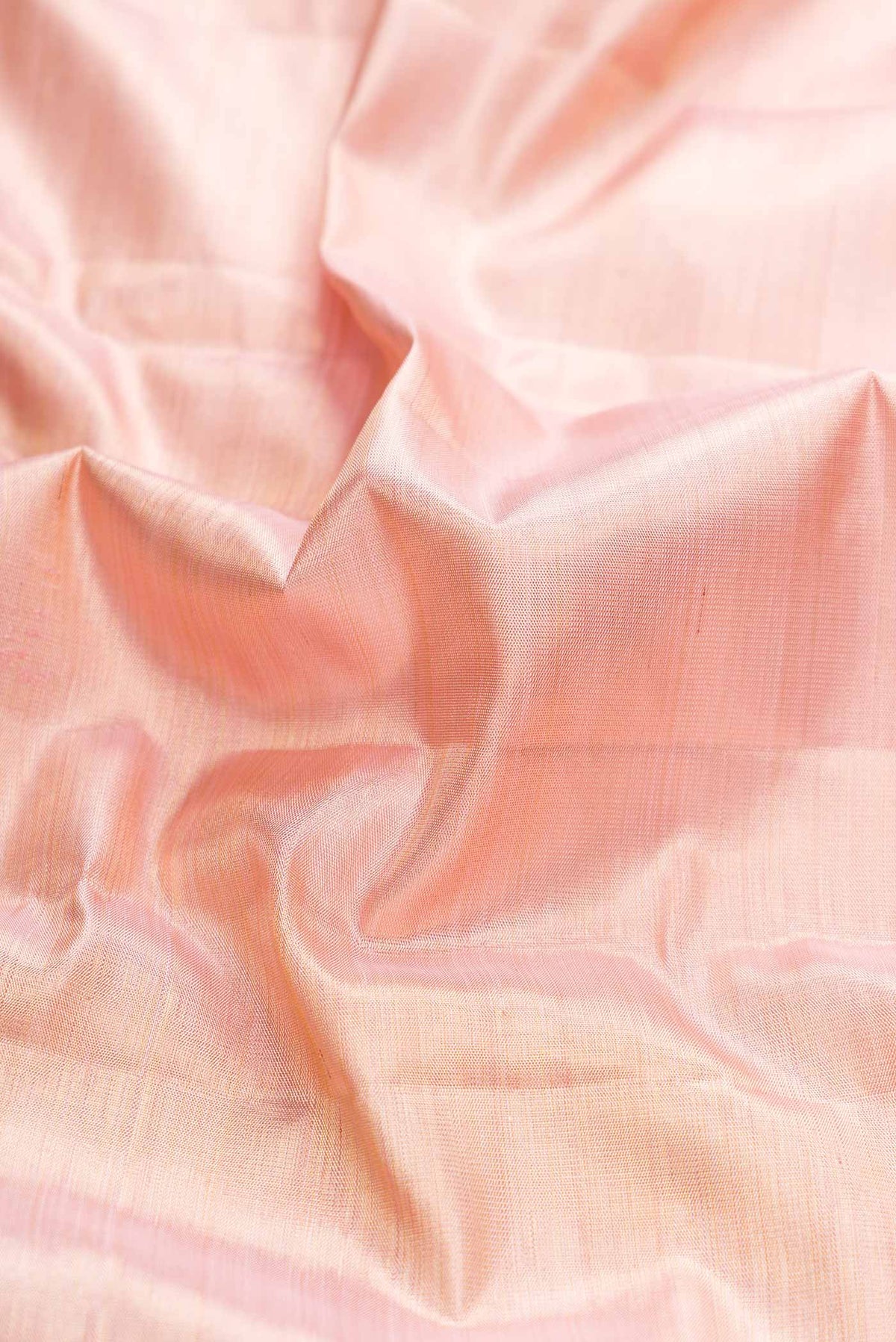 Close up of Pink Dual Tone Kanchipuram Saree with Jacquard design on the body and Zari Border displaying folds