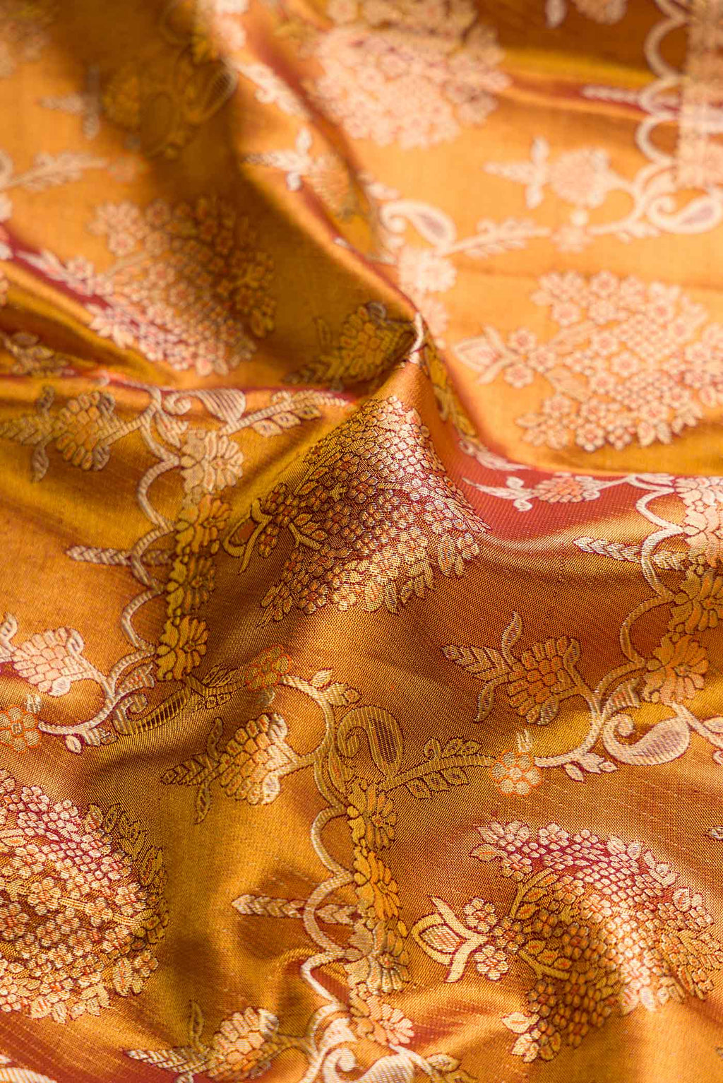 Close up of Gold Dual Tone Kanchipuram Tissue Silk Saree with Zari Brocade on the body and Zari Border displaying folds