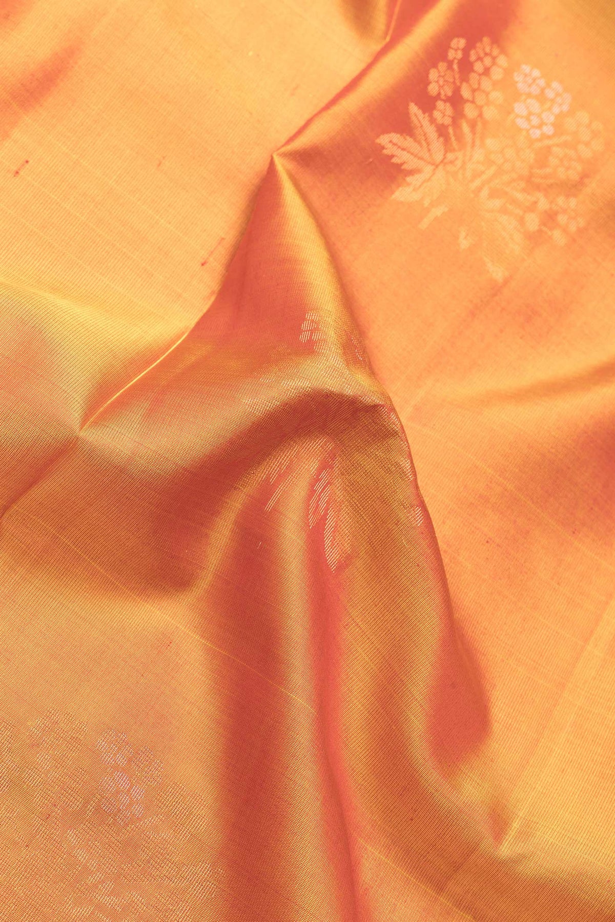 Close up of Mustard Dual Tone Soft Silk Saree with Zari Butta on the body and Zari Border.  displaying folds