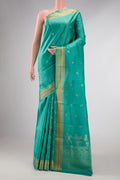 Green Dual Tone Soft Silk Saree with Zari Butta on the body and Zari Border displayed on a mannequin