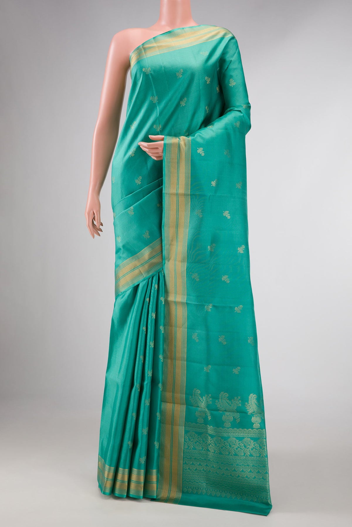 Green Dual Tone Soft Silk Saree with Zari Butta on the body and Zari Border displayed on a mannequin