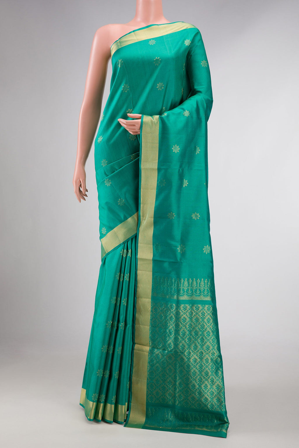 Green Dual Tone Soft Silk Saree with Zari Butta on the body and Zari Border displayed on a mannequin