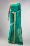 Green Dual Tone Soft Silk Saree with Zari Butta on the body and Zari Border displayed on a mannequin