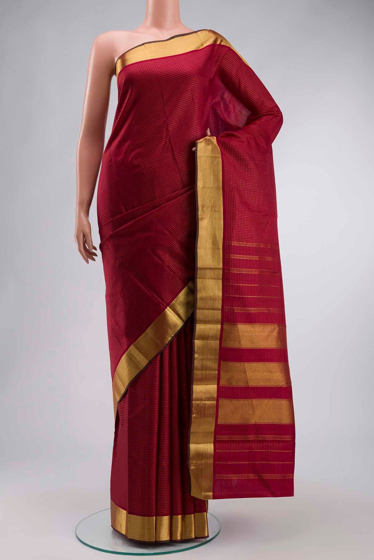 Maroon Kanchipuram Silk Saree with Checked design on the body and Zari Border displayed on a mannequin
